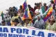 Bolivia's President Luis Arce, center, waves as he walks wit