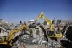 People search the rubble of a prison facility hit by a Saudi