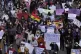 Demonstrators shout slogans and march to protest against gen