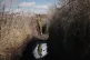 A Ukrainian serviceman pauses while walking to a frontline p