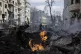 Firefighters extinguish flames outside an apartment house af