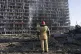 A firefighter looks at the destruction caused after shelling