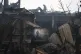 Firefighters work to extinguish a fire at a house after a Ru