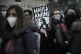 A woman shows a placard with a photo of of Iranian Mahsa Ami