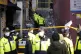 Police officers work at the scene of a fatal crowd surge, in