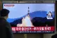 A TV screen shows a file image of North Korea's missile laun