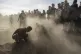 Syrian Kurds attend a funeral of people killed in Turkish ai