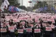 Members of the Korean Confederation of Trade Unions hold up 