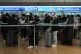 Passengers wait in line to board a plane to China at the Inc