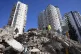 Emergency teams search for people in the rubble of a destroy
