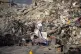 A man sleeps in front of a destroyed building in Kahramanmar