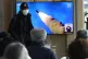 A TV screen shows a file image of North Korea's missile laun