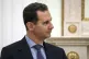 Syrian President Bashar Assad listens to Russian President V