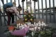 A girl lights candle during a vigil for the victims of a fir