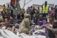 South Sudanese who fled from Sudan sit outside a nutrition c