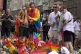 People react as they lay flowers at the scene of a shooting 