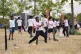 A kid hits a baseball during the MLB First Pitch Festival, a