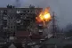 An explosion erupts from a block of flats after a Russian ar