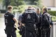 Police officers coordinate the search for a wild animal in a