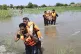 EMERGENCY: Rescue workers help villagers evacuate from a flo