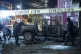 Police inspect a truck that exploded outside an office used 