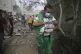 Palestinian medic takes a baby pulled out of buildings destr