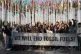 Members of Greenpeace gather for a photo around a sign that 