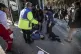People stay next to an injured man after an explosion in Ker