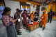 Polling officials unseal an electronic voting machine to cou