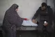 Palestinians mourn a child killed by an Israeli bombardment 