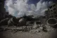 A Palestinian stands on top of a mosque destroyed in an Isra