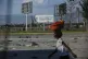 A woman walks past the international airport in Port-au-Prin