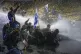 Police use water cannon to disperse demonstrators during a p