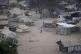 People stand by their houses in Juba, South Sudan, February 