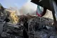 Emergency services work at a building hit by an air strike i