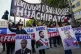 Workers of the Chilean Huachipato steel company hold portrai