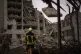 Firefighters work on a building that was partially destroyed