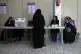 Staff members of a polling station attend to their stations 