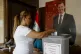 A woman casts her vote at a polling station during the Syria