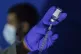 A family nurse practitioner prepares a syringe with the Mpox