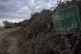 An Israeli tank sits near the Israeli-Lebanese border, as se
