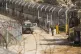 An Israeli soldier stands guard at a security fence gate nea