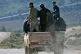 Turkey-backed Syrian opposition fighters atop a machine gun 