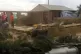 Video footage of people standing hear a house damaged by Cyc