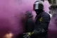 Catalan regional police officers stand amid smoke during cla