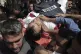 Mourners carry the body of Palestinian cameraman who was kil