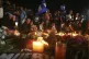 Demonstrators hold a candlelight vigil in honor of those who