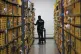 An employee of Amazon PrimeNow stacks shelves