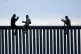 Two Honduran men pose as a photographer, at left, takes thei