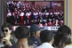 People watch a TV screen showing an image of North Korean le